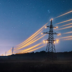 glowing powerlines and tall transmission towers at night